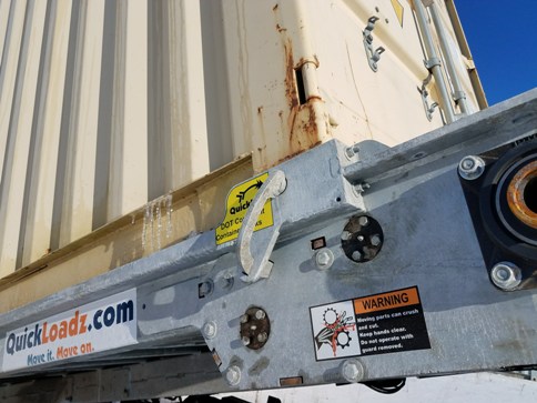 A QuickLoadz trailer with a container locked in on the bed. 