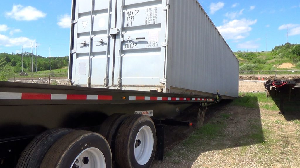 Chains pull the bed under the container